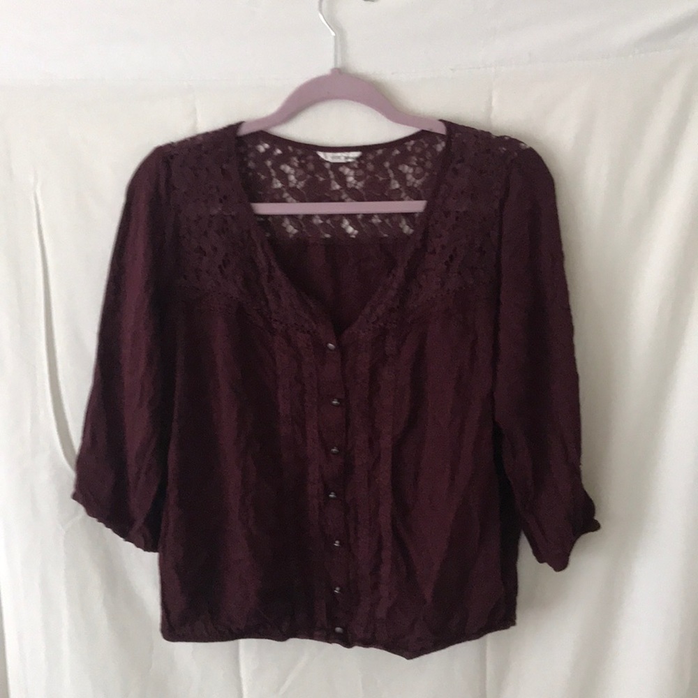 Maroon blouse with lace detailing.